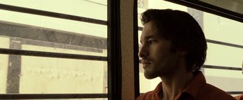 Movie still from “S.W.A.T.” (2003), directed by Clark Johnson – A person looking out of a window; Close Up shot, Low angle