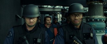 Movie still from “S.W.A.T.” (2003), directed by Clark Johnson – A group of men standing next to each other on top of a train; Close Up shot, Over the shoulder angle