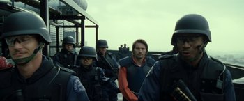 Movie still from “S.W.A.T.” (2003), directed by Clark Johnson – A group of men standing next to each other; Medium shot, Over the shoulder angle