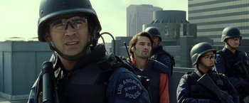 Movie still from “S.W.A.T.” (2003), directed by Clark Johnson – A group of men standing next to each other on top of a building; Close Up shot, Low angle