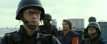 Movie still from “S.W.A.T.” (2003), directed by Clark Johnson – A group of men standing next to each other on top of a hill; Close Up shot, Low angle