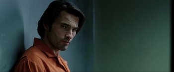 Movie still from “S.W.A.T.” (2003), directed by Clark Johnson – A person wearing an orange shirt; Close Up shot, Over the shoulder angle