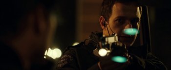 Movie still from “S.W.A.T.” (2003), directed by Clark Johnson – A police officer is holding a gun in his hand; Close Up shot, Over the shoulder angle