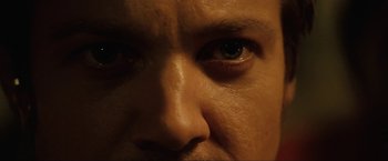 Movie still from “S.W.A.T.” (2003), directed by Clark Johnson – A man's face with a dark background; Extreme Close Up shot, Low angle