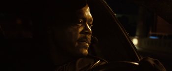 Movie still from “S.W.A.T.” (2003), directed by Clark Johnson – A man's face in the dark; Close Up shot, Over the shoulder angle