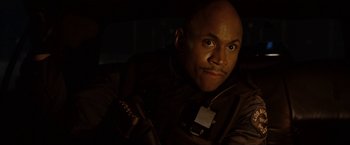 Movie still from “S.W.A.T.” (2003), directed by Clark Johnson – A man with a badge around his neck; Close Up shot, Low angle