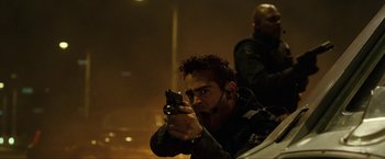 Movie still from “S.W.A.T.” (2003), directed by Clark Johnson – A man holding a gun while standing next to another man; Close Up shot, Low angle