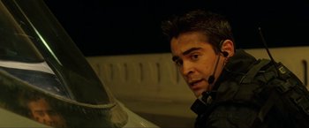 Movie still from “S.W.A.T.” (2003), directed by Clark Johnson – A man with a headset looking at the camera; Close Up shot, Over the shoulder angle