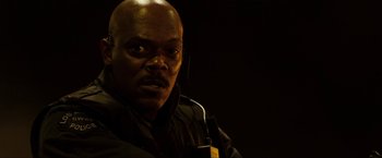 Movie still from “S.W.A.T.” (2003), directed by Clark Johnson – A man with a black jacket and a black background; Close Up shot, Low angle