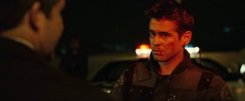 Movie still from “S.W.A.T.” (2003), directed by Clark Johnson – A man in a black shirt is looking at the camera; Close Up shot, Over the shoulder angle