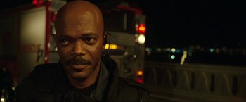 Movie still from “S.W.A.T.” (2003), directed by Clark Johnson – A man with a bald head wearing a black jacket; Close Up shot, Over the shoulder angle