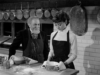 Movie still from “Sabrina” (1954), directed by Billy Wilder – An old man and a young woman in a kitchen; Medium shot, High angle