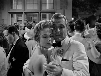 Movie still from “Sabrina” (1954), directed by Billy Wilder – A man and a woman are dancing in a crowd; Medium shot, Low angle