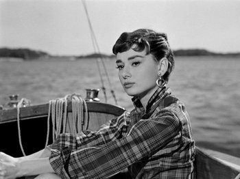 Movie still from “Sabrina” (1954), directed by Billy Wilder – A woman sitting on a boat in the water; Close Up shot, High angle