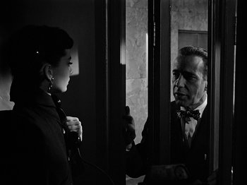 Movie still from “Sabrina” (1954), directed by Billy Wilder – A man and a woman are talking to each other; Medium shot, Low angle