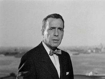 Movie still from “Sabrina” (1954), directed by Billy Wilder – An older man wearing a suit and a bow tie; Close Up shot, Low angle