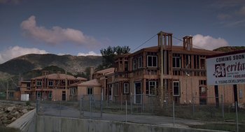 Movie still from “Safe” (1995), directed by Todd Haynes – A group of houses that are under construction; Extreme Wide shot, Low angle