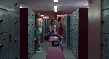Movie still from “Safe” (1995), directed by Todd Haynes – A group of people standing in a room with lockers; Wide shot, Low angle