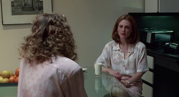 Movie still from “Safe” (1995), directed by Todd Haynes – Two women sitting at a table with a cup of coffee; Medium shot, Over the shoulder angle