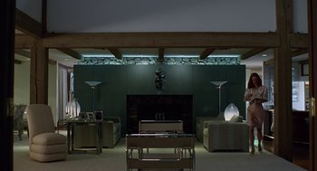 Movie still from “Safe” (1995), directed by Todd Haynes – A living room filled with furniture next to a fire place; Wide shot, Low angle