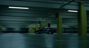Movie still from “Safe” (1995), directed by Todd Haynes – A car parked in an empty parking garage; Extreme Wide shot, High angle