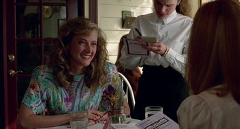 Movie still from “Safe” (1995), directed by Todd Haynes – A woman sitting at a table in front of a waitress; Medium shot, Over the shoulder angle