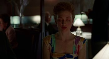 Movie still from “Safe” (1995), directed by Todd Haynes – A woman in a colorful dress is looking down; Close Up shot, Over the shoulder angle