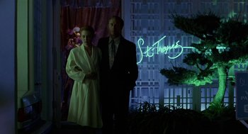 Movie still from “Safe” (1995), directed by Todd Haynes – A man and a woman standing next to each other; Medium shot, Low angle