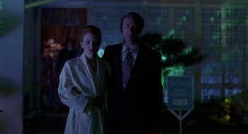 Movie still from “Safe” (1995), directed by Todd Haynes – A man and a woman standing next to each other; Medium shot, Low angle