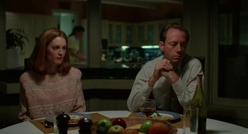 Movie still from “Safe” (1995), directed by Todd Haynes – A man and a woman sitting at a dinner table; Medium shot, Over the shoulder angle