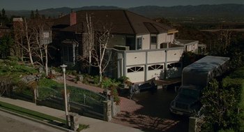 Movie still from “Safe” (1995), directed by Todd Haynes – An aerial view of a house with a car parked in front of it; Extreme Wide shot, High angle