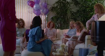 Movie still from “Safe” (1995), directed by Todd Haynes – A group of women sitting on a couch with balloons in the background; Wide shot, High angle