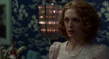 Movie still from “Safe” (1995), directed by Todd Haynes – A person with curly hair wearing a necklace; Close Up shot, Over the shoulder angle