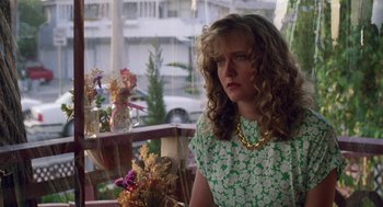 Movie still from “Safe” (1995), directed by Todd Haynes – A woman sitting at a table in front of a window; Close Up shot, Low angle