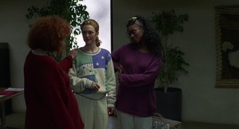 Movie still from “Safe” (1995), directed by Todd Haynes – A group of women standing next to each other in a room; Medium shot, Over the shoulder angle
