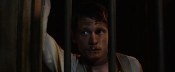 Movie still from “Godless” (2017), directed by Scott Frank – A person behind a fence; Close Up shot, High angle