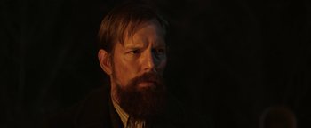 Movie still from “Godless” (2017), directed by Scott Frank – A man with a long beard is looking at the camera; Close Up shot, Low angle
