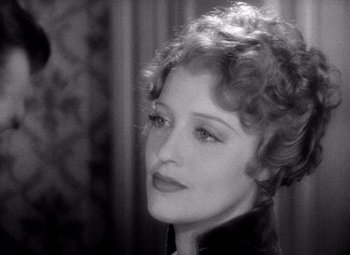 Movie still from “San Francisco” (1936), directed by W.S. Van Dyke – An old photo of an older woman with short curly hair; Close Up shot, High angle