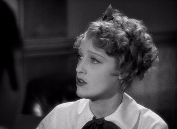 Movie still from “San Francisco” (1936), directed by W.S. Van Dyke – A black - and - white photo of a woman in a shirt and tie; Close Up shot, High angle