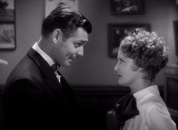 Movie still from “San Francisco” (1936), directed by W.S. Van Dyke – A man and a woman looking at one another; Close Up shot, Over the shoulder angle