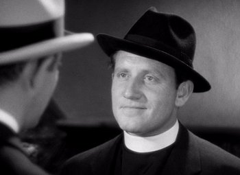 Movie still from “San Francisco” (1936), directed by W.S. Van Dyke – A man wearing a hat and a priest's outfit; Close Up shot, Over the shoulder angle