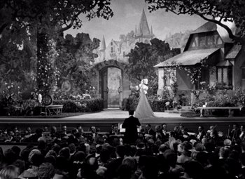 Movie still from “San Francisco” (1936), directed by W.S. Van Dyke – An audience watching a performance of a fairy tale; Extreme Wide shot, High angle