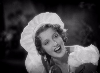 Movie still from “San Francisco” (1936), directed by W.S. Van Dyke – An old photo of a woman with a hat on; Close Up shot, Low angle