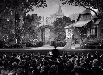 Movie still from “San Francisco” (1936), directed by W.S. Van Dyke – An audience watching a performance of shakespeare's " the taming of the shrew "; Extreme Wide shot, High angle