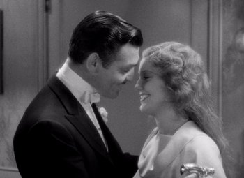 Movie still from “San Francisco” (1936), directed by W.S. Van Dyke – A man and a woman smiling at each other; Close Up shot, High angle