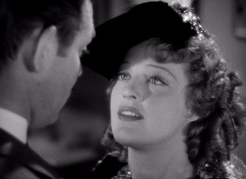 Movie still from “San Francisco” (1936), directed by W.S. Van Dyke – An old black and white photo of a man and a woman; Close Up shot, Over the shoulder angle