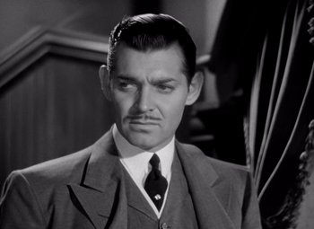 Movie still from “San Francisco” (1936), directed by W.S. Van Dyke – A man in a suit and a tie; Close Up shot, Low angle