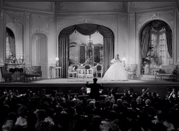 Movie still from “San Francisco” (1936), directed by W.S. Van Dyke – A crowd of people watching a performance in a theater; Extreme Wide shot, High angle