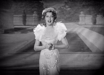 Movie still from “San Francisco” (1936), directed by W.S. Van Dyke – An old photo of a woman in a white dress; Medium shot, Low angle