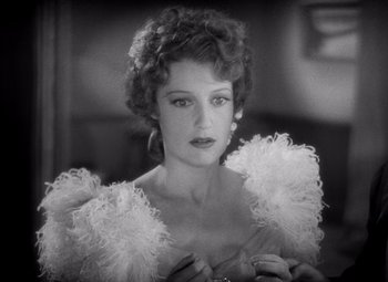 Movie still from “San Francisco” (1936), directed by W.S. Van Dyke – A black - and - white photo of a woman in a dress; Close Up shot, Over the shoulder angle